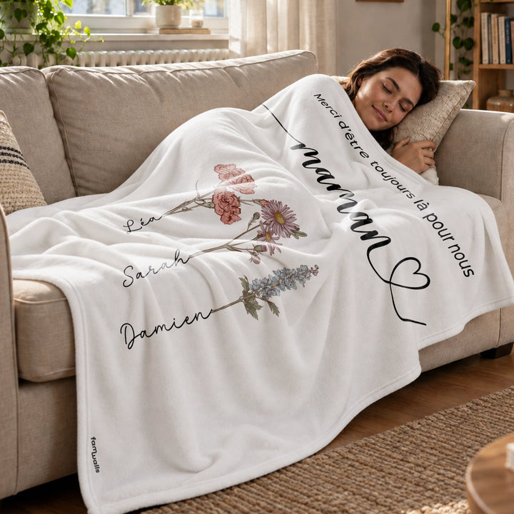 Femme endormie sur un canapé sous le plaid blanc Des fleurs pour maman market_france